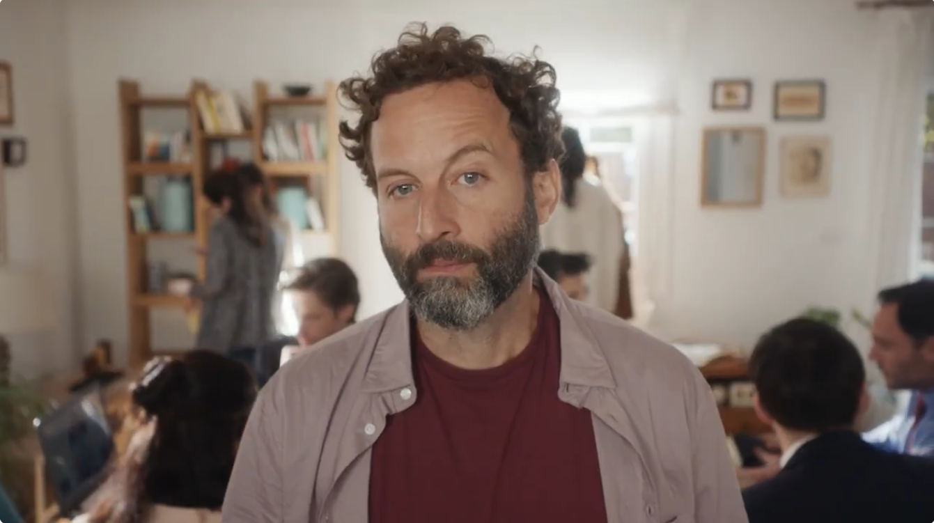A man stands among the growing crowd in the Xfinity Lemonade commercial